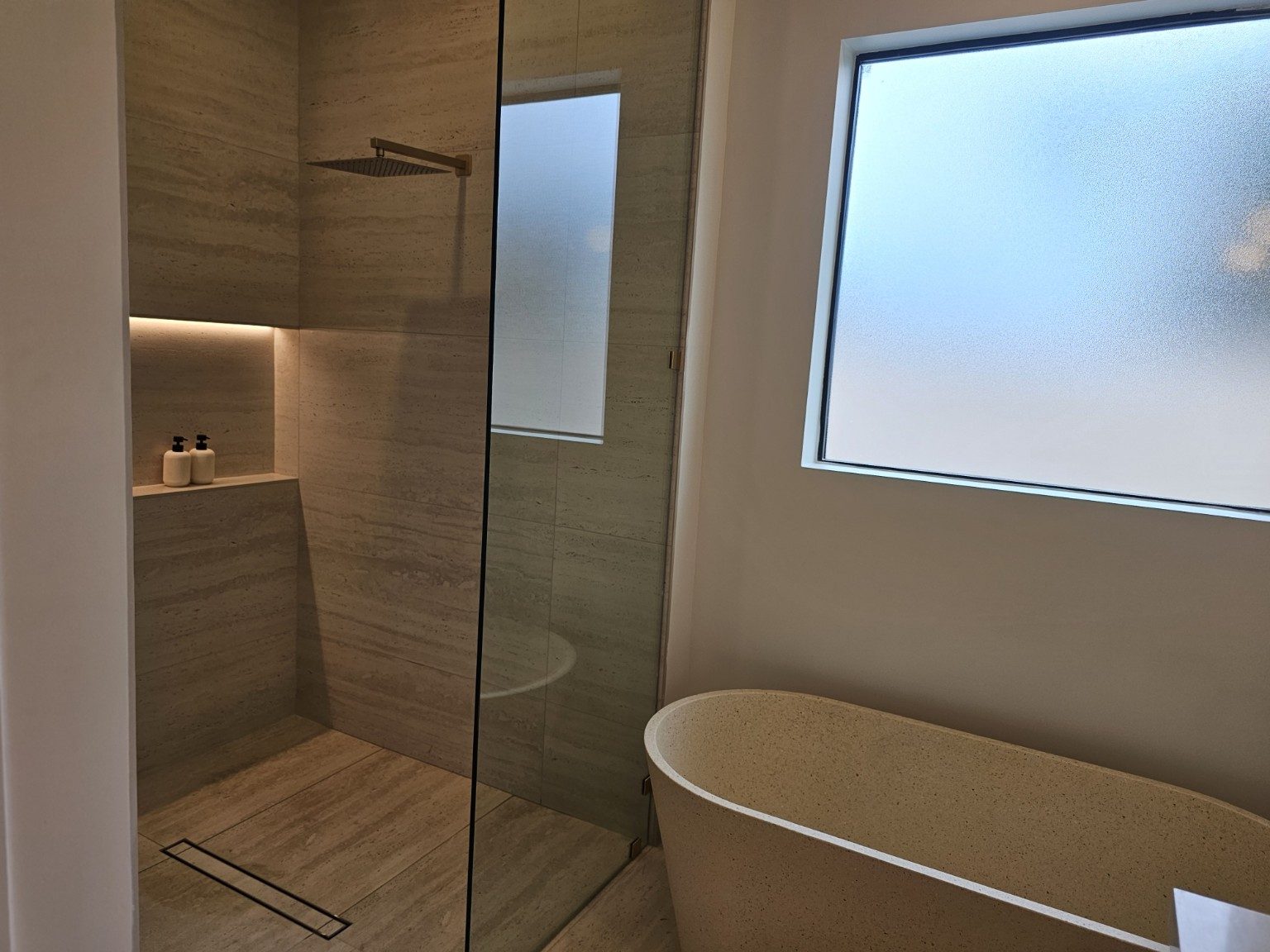 Modern bathroom with glass shower and freestanding tub